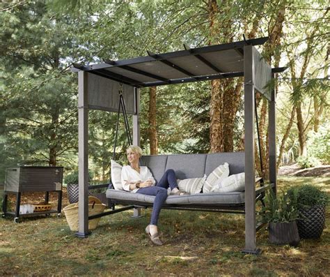 Description This three-person pergola swing by Broyhill easily transforms into a lounging daybed with tufted back olefin fabric cushions in a neutral gray. . Broyhill pergola daybed swing